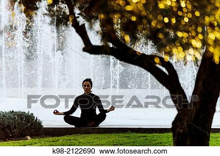 Woman practicing Yoga, Riera Park, Palma, Mallorca, Balearic Islands, Spain. View Large Photo Image Stock Image - Woman practicing Yoga, Riera Park, Palma, Mallorca, Balearic Islands, Spain.. Fotosearch
