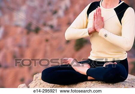 Stock Image - Woman practicing yoga. Utah, USA. Fotosearch