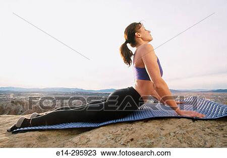 Stock Image - Woman practicing yoga. Utah, USA. Fotosearch