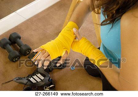 Woman preparing for kick boxing class View Large Photo Image Stock Photo - Woman preparing for kick boxing class. Fotosearch