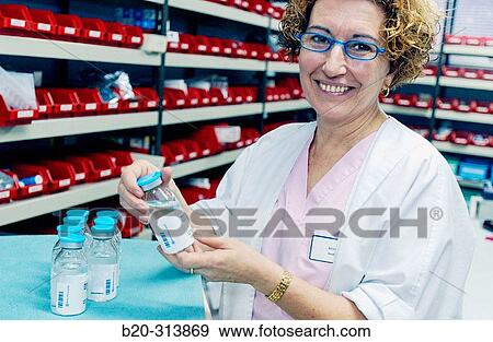 Woman preparing medicine at chemist of hospital View Large Photo Image Stock Photo - Woman preparing medicine at chemist of hospital. Fotosearch