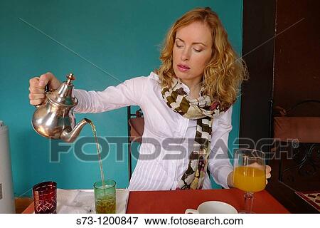 Woman preparing tea in a Marrakesh restaurant, Morocco View Large Photo Image Stock Photo - Woman preparing tea in a Marrakesh restaurant, Morocco. Fotosearch