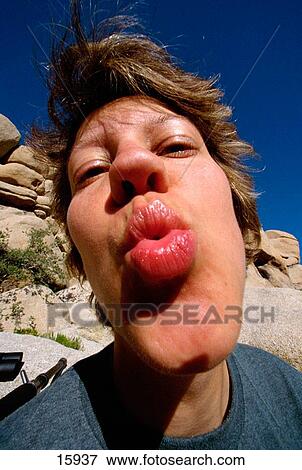 Woman puckering lips and kissing View Large Photo Image Stock Photo - Woman puckering lips and kissing. Fotosearch