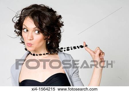 Woman pulling her neckless with her finger Surprise and suspicious expression in her face View Large Photo Image Stock Photography - Woman pulling her neckless with her finger Surprise and suspicious expression in her face. Fotosearch