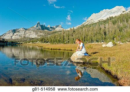 Woman purifying water at Echo Lake under Echo Peaks and Matthes Crest, Yosemite National Park, California View Large Photo Image Stock Photo - Woman purifying water at Echo Lake under Echo Peaks and Matthes Crest, Yosemite National Park, California. Fotosearch