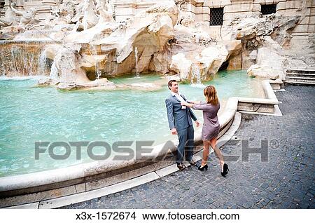 Woman pushing man into the Trevi fountain as a joke View Large Photo Image Picture - Woman pushing man into the Trevi fountain as a joke. Fotosearch