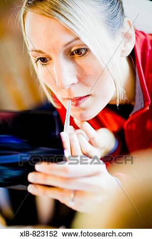 woman putting on lipstick View Large Photo Image Stock Image - woman putting on lipstick. Fotosearch