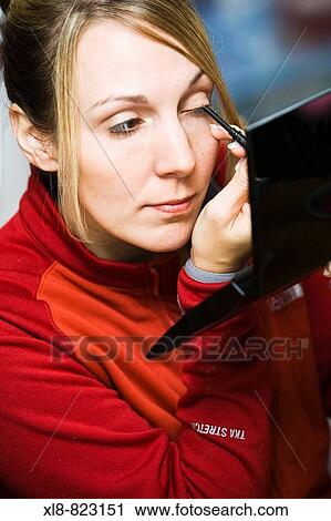 Woman putting on makeup View Large Photo Image Stock Image - Woman putting on makeup. Fotosearch
