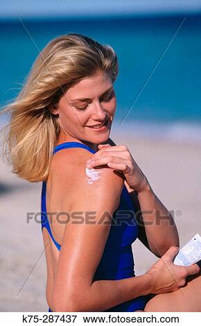 woman putting on suntan lotion View Large Photo Image Stock Photo - woman putting on suntan lotion. Fotosearch
