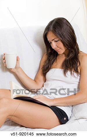 Woman reading a book at home View Large Photo Image Stock Photography - Woman reading a book at home. Fotosearch