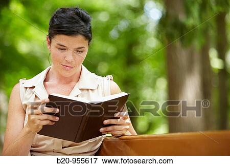 Woman reading a book in a garden, spa-relais. Lierganes hotel and spa, Cantabria, Spain View Large Photo Image Stock Photo - Woman reading a book in a garden, spa-relais. Lierganes hotel and spa, Cantabria, Spain. Fotosearch