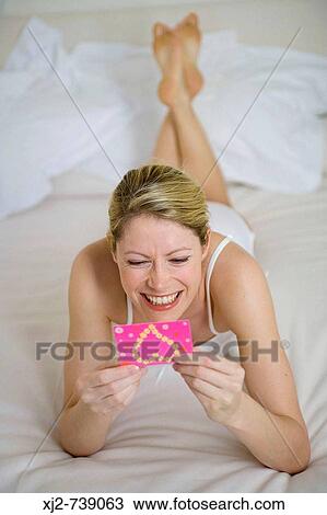 Woman reading a congratulations card View Large Photo Image Stock Image - Woman reading a congratulations card. Fotosearch