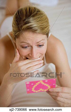 Woman reading a congratulations card View Large Photo Image Stock Photograph - Woman reading a congratulations card. Fotosearch