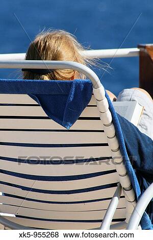 Stock Photo - Woman reading aboard a Cruise Ship across the Mediterranean sea. Fotosearch
