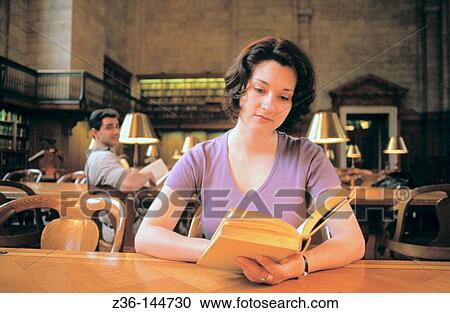 Woman reading at library View Large Photo Image Stock Image - Woman reading at library. Fotosearch