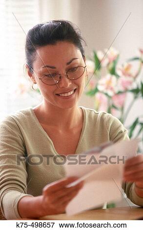 Woman reading correspondence View Large Photo Image Stock Photo - Woman reading correspondence. Fotosearch