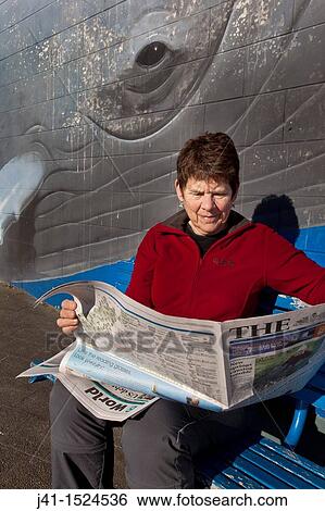 Woman reading morning newspaper, Humpback whale mural on library wall, Kaikoura, North Canterbury, South Island, New Zealand View Large Photo Image Stock Photograph - Woman reading morning newspaper, Humpback whale mural on library wall, Kaikoura, North Canterbury, South Island, New Zealand. Fotosearch