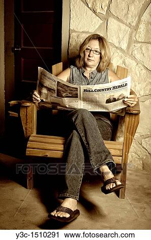 Stock Image - Woman reading newspaper. Fotosearch