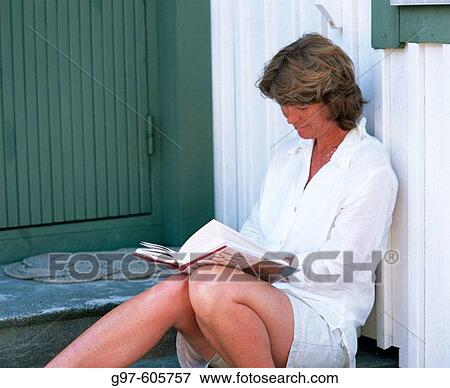 Woman reading outdoors View Large Photo Image Stock Photo - Woman reading outdoors. Fotosearch