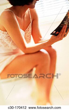 Woman reads while sitting on toilet View Large Photo Image Stock Image - Woman reads while sitting on toilet. Fotosearch