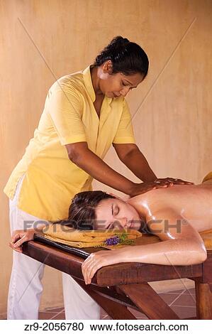 Woman receiving an Ayurveda herbal oil body massage, an ancient form of healing and well-being, Sri Lanka, Asia. View Large Photo Image Stock Image - Woman receiving an Ayurveda herbal oil body massage, an ancient form of healing and well-being, Sri Lanka, Asia.. Fotosearch
