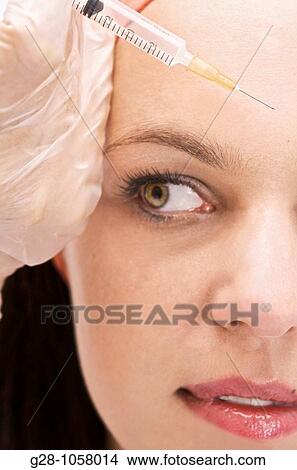 woman receiving an injection of botox for a jaw and face contour lifting View Large Photo Image Picture - woman receiving an injection of botox for a jaw and face contour lifting. Fotosearch
