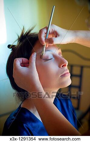 Woman receiving make-up application View Large Photo Image Picture - Woman receiving make-up application. Fotosearch