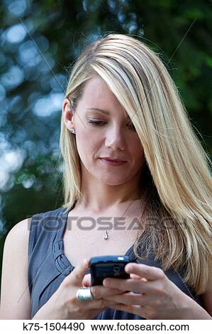 Woman receiving or sending text message View Large Photo Image Stock Image - Woman receiving or sending text message. Fotosearch