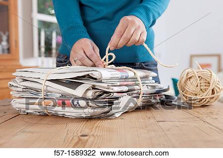 Woman recycling a bundle of newspapers View Large Photo Image Stock Image - Woman recycling a bundle of newspapers. Fotosearch