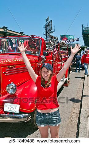 Woman Red Sox fan at famous historic Fenway Park in Boston Mass in front old Red Sox Fire Truck in baseball mode View Large Photo Image Stock Photo - Woman Red Sox fan at famous historic Fenway Park in Boston Mass in front old Red Sox Fire Truck in baseball mode. Fotosearch