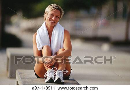 Woman relaxes after exercise View Large Photo Image Stock Image - Woman relaxes after exercise. Fotosearch