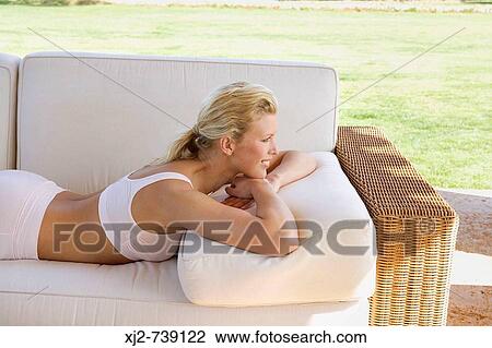 Woman relaxing at home outdoors View Large Photo Image Stock Image - Woman relaxing at home outdoors. Fotosearch