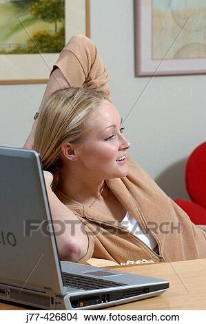 Picture - Woman relaxing at home.. Fotosearch