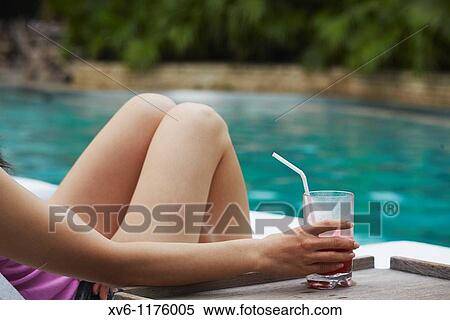 Woman relaxing by pool at Grand Hyatt hotel, Hong Kong, China MR View Large Photo Image Stock Photography - Woman relaxing by pool at Grand Hyatt hotel, Hong Kong, China MR. Fotosearch