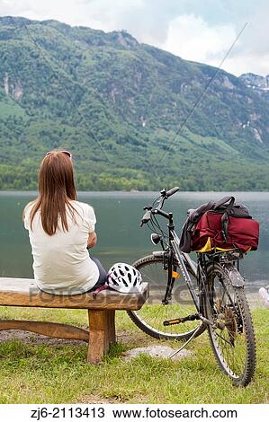 Woman relaxing by the lake of Bohinj, Slovenia Gorenjska Julian Alps. View Large Photo Image Stock Image - Woman relaxing by the lake of Bohinj, Slovenia Gorenjska Julian Alps.. Fotosearch