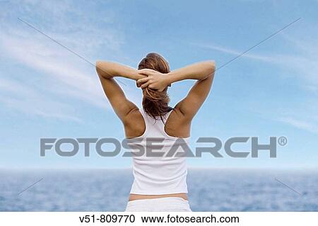 Woman relaxing by the sea View Large Photo Image Stock Image - Woman relaxing by the sea. Fotosearch