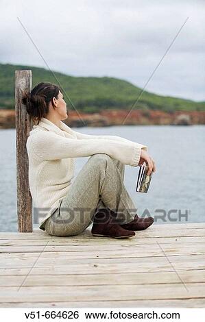 Woman relaxing by the sea View Large Photo Image Stock Photograph - Woman relaxing by the sea. Fotosearch