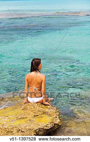 Stock Photo - Woman relaxing in a beach in Formentera, Balearic Islands, Spain. Fotosearch