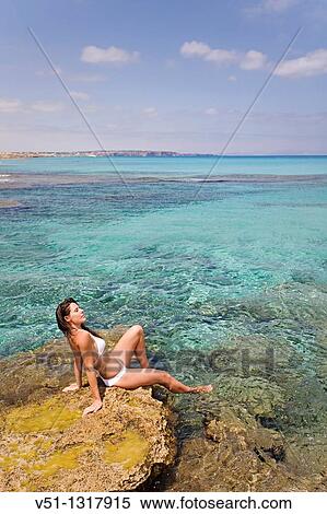 Stock Photography - Woman relaxing in a beach in Formentera, Balearic Islands, Spain. Fotosearch