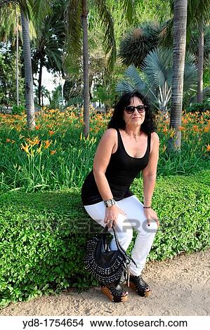 Picture - Woman relaxing in a park, Malaga, Andalucia, Spain. Fotosearch
