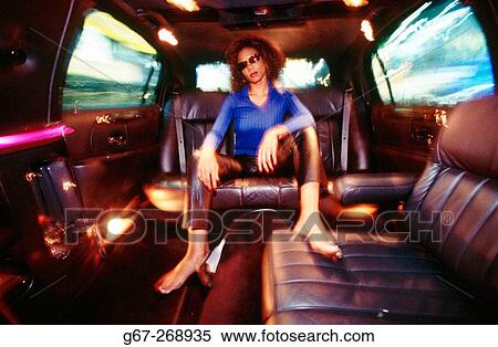 Woman relaxing in the back of limo. Times Square. New York City. USA View Large Photo Image Stock Photography - Woman relaxing in the back of limo. Times Square. New York City. USA. Fotosearch