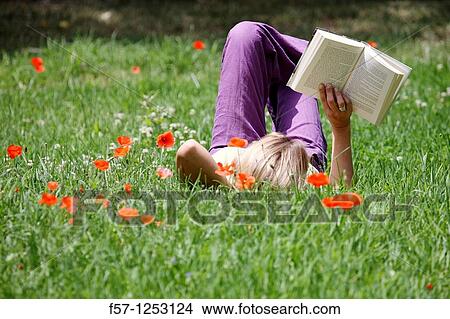 Woman relaxing in the grass View Large Photo Image Picture - Woman relaxing in the grass. Fotosearch