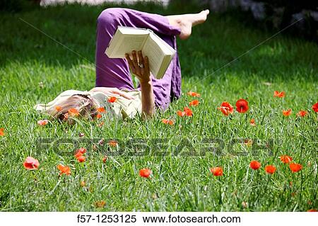 Woman relaxing in the grass View Large Photo Image Stock Photography - Woman relaxing in the grass. Fotosearch
