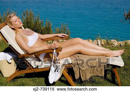 Woman relaxing outdoors View Large Photo Image Stock Photography - Woman relaxing outdoors. Fotosearch