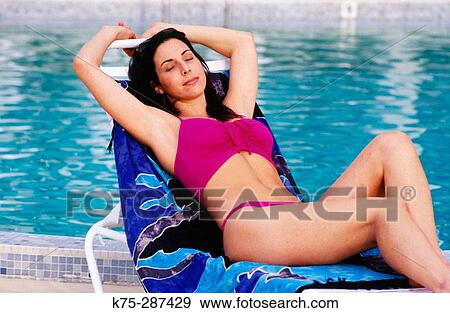 woman relaxing poolside View Large Photo Image Stock Photo - woman relaxing poolside. Fotosearch