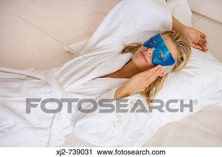Woman relaxing with eye mask View Large Photo Image Stock Image - Woman relaxing with eye mask. Fotosearch