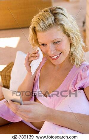 Woman removing make up with cleansing facial wipe View Large Photo Image Stock Photo - Woman removing make up with cleansing facial wipe. Fotosearch