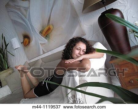 Woman resting at home View Large Photo Image Stock Photo - Woman resting at home. Fotosearch