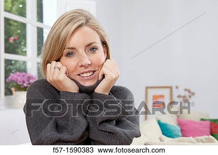 Stock Image - Woman resting her head in her hands. Fotosearch