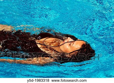 Woman resting in swimming pool, summertime View Large Photo Image Stock Photo - Woman resting in swimming pool, summertime. Fotosearch
